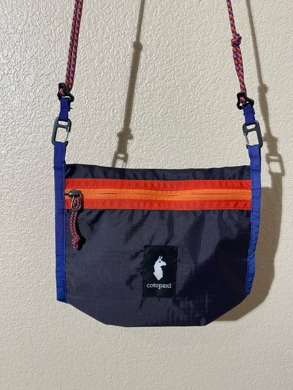 cotopaxi navy belt/crossbody bag with orange zipper and blue trim